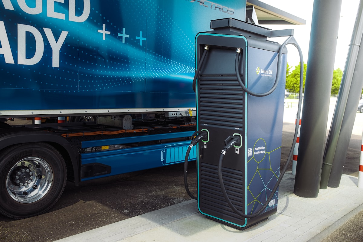 Electric heavy-goods truck charging at a DC fast-charging station